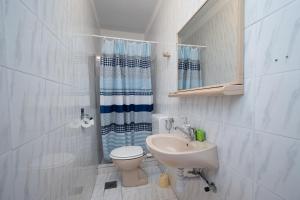 a small bathroom with a toilet and a sink at Apartments and rooms with parking space Zubovici, Pag - 16063 in Zubovići