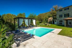 a swimming pool in a yard with a gazebo at Holiday house with a swimming pool Buzet, Central Istria - Sredisnja Istra - 22842 in Buzet