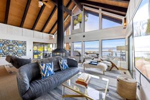 a living room with a couch and a table at Towering Pines Lakefront - 3 BR w Hot Tub & Buoy in Tahoe City
