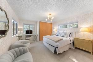 a bedroom with a bed and a desk and chairs at Towering Pines Lakefront - 3 BR w Hot Tub & Buoy in Tahoe City