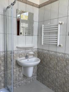 a bathroom with a sink and a mirror at Zamek Nowęcin in Łeba