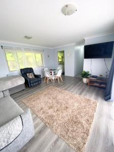 ein Wohnzimmer mit einem Sofa und einem Tisch in der Unterkunft Marcel Towers Holiday Apartments in Nambucca Heads
