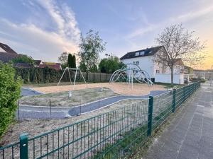 a park with a playground in front of a building at Schick, gemütlich & Nähe Therme in Bad Lippspringe