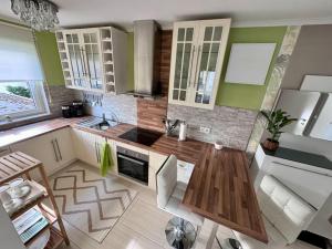 a kitchen with green and white walls and wooden counters at Schick, gemütlich & Nähe Therme in Bad Lippspringe