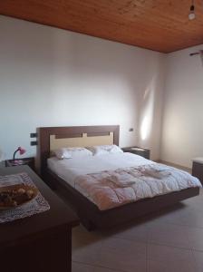 a bedroom with a large bed and a wooden ceiling at Private House Durres in Durrës