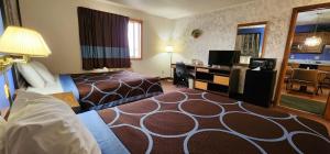 a hotel room with a bed and a desk at Stay Express Collection - Hotel Iron Mountain Inn & Suites in Iron Mountain