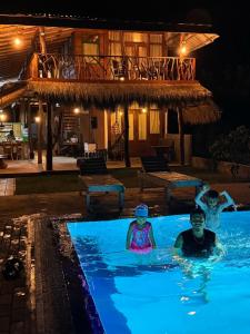 two people in a swimming pool at a resort at Sigiriya Elegant Resort in Sigiriya