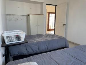 a bedroom with a bed with a basket on it at Habitaciones en Casa Casiopea in Tijuana