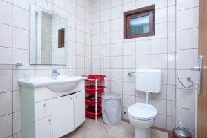 a white bathroom with a toilet and a sink at Apartments with parking space Pirovac, Sibenik - 22567 in Pirovac +39 photos