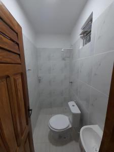 a bathroom with a toilet and a sink at Camping & hostel tô á toa jeri in Jericoacoara