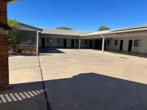 an empty parking lot in front of a building at Abajaz Motel-All Rooms Updated-May 2024 in Longreach