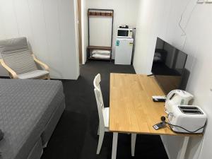 a small room with a table and a bed and a refrigerator at Abajaz Motel-All Rooms Updated-May 2024 in Longreach