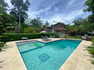 a swimming pool in the backyard of a house at Finca Cristal con Piscina Room Blue in Puerto Viejo