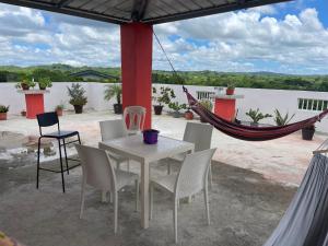 a table and chairs and a hammock on a patio at Plataview Apartahotel apt 4A in Monte Plata