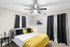Suburban Bliss Getaway Wi-Fi Parking Long Stay في Center Point: غرفة نوم مع سرير ومروحة سقف