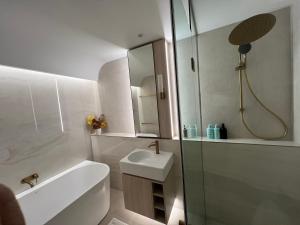a white bathroom with a sink and a shower at Luxury accommodation in Sydney
