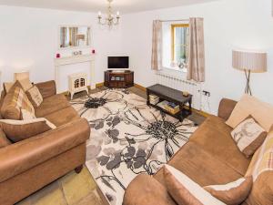 a living room with two couches and a fireplace at The Barn - 27977 in Whalley