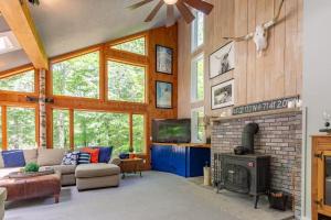 a living room with a couch and a fireplace at Loon Mtn Pool Hot Tub Firepit Sleeps 17 in Lincoln