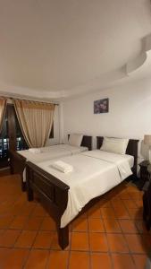 a bedroom with a large bed with white sheets at Suansuk pattaya in Jomtien Beach +29 photos