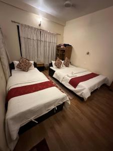 Voodi või voodid majutusasutuse Cherry Garden Pokhara toas
