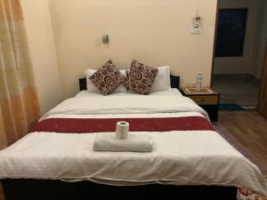 Voodi või voodid majutusasutuse Cherry Garden Pokhara toas