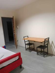 a room with a table and two chairs and a bed at Wjv Inn Talamban in Cebu City