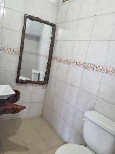 a bathroom with a toilet and a mirror at Rancho Mi Cielo 