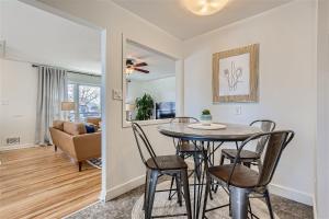 a dining room and living room with a table and chairs at Newly Furnished & Updated • 15 min to Denver in Northglenn