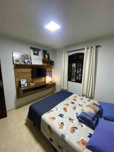 a bedroom with a bed in a room with a window at Casa 86 Quitandinha Petrópolis in Petrópolis