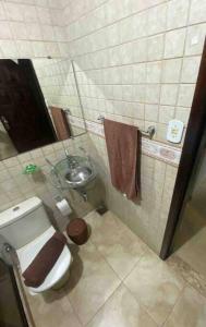 a small bathroom with a toilet and a sink at Casa 86 Quitandinha Petrópolis in Petrópolis