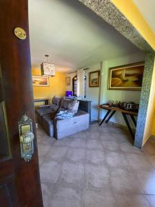 a living room with a couch and a table at Casa 86 Quitandinha Petrópolis in Petrópolis