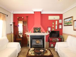 a living room with red walls and a fireplace at Villa Murcia, 5 dormitorios, 10 personas - ES-220-34 in Alcantarilla