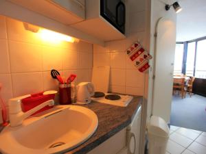 a small bathroom with a sink and a stove at Studio Avoriaz, 1 pièce, 3 personnes - FR-1-314-280 in Morzine