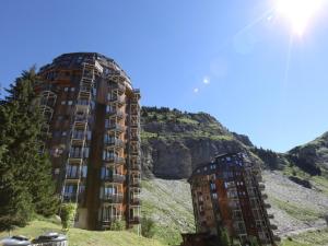 two tall buildings sitting on top of a hill at Studio Avoriaz, 1 pièce, 3 personnes - FR-1-314-280 in Morzine