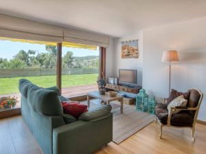 a living room with a couch and a television at Villa Vall-llòbrega, 5 dormitorios, 10 personas - ES-329-7 in Vall-Llobrega