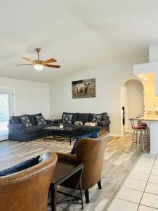 a living room with a couch and a table at Casa Feliz Arizona in Fort Mohave