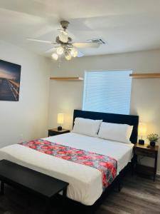 a bedroom with a bed with a ceiling fan at Casa Feliz Arizona in Fort Mohave