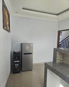a stainless steel refrigerator in a room with a microwave at The Lucky Canggu 2 in Canggu +19 photos