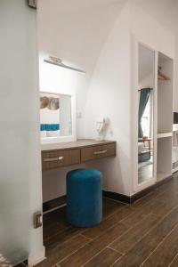 a bathroom with a blue stool and a mirror at Tube Resort By EHM in Koh Rong Sanloem