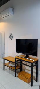 a flat screen tv on a table in a room at Kidona's House in Da Nang +23 photos