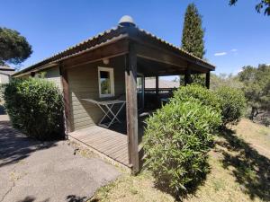 a wooden gazebo with a table on it at Chalet Agde, 3 pièces, 6 personnes - FR-1-607-194 in Agde