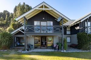 a house with a balcony on the front of it at Rakaia Gorge Views - Mt Hutt in Windwhistle