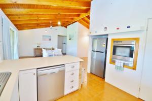 a kitchen with a white counter and a refrigerator at Starfire Close 3 - Kalbarri, WA in Kalbarri