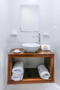 a bathroom with a counter with a sink and towels at El puente Hotel Boutique in Arequipa