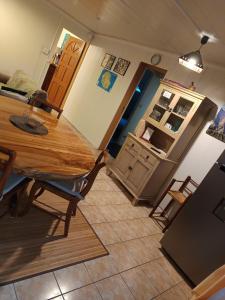 a kitchen with a wooden table and a refrigerator at Cascades de la mare à poule d'eau in Salazie
