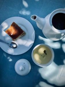 a plate with a piece of cake and a cup of coffee at Guest house on Akmatbai-Ata 29 in Cholpon-Ata