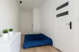 Ένα ή περισσότερα κρεβάτια σε δωμάτιο στο Centrum 2 Łodz Struga 27a