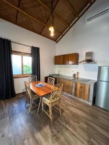 uma cozinha e sala de jantar com mesa e cadeiras em ANITSA RESORT em El Nido