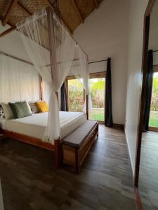 a bedroom with a bed with a mosquito net at ANITSA RESORT in El Nido