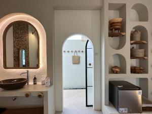 a bathroom with a sink and a mirror at El Tropico Boutique Hotel in Kuta Lombok